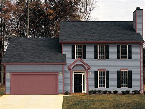 grey house with red metal roof|gray exterior with black trim.